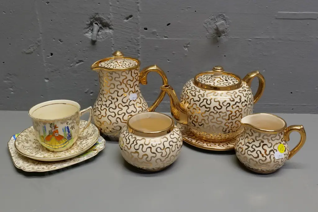 Suglow gold and cream 4-piece tea set with pot stand and an Empire crinoline lady trio Image 1++