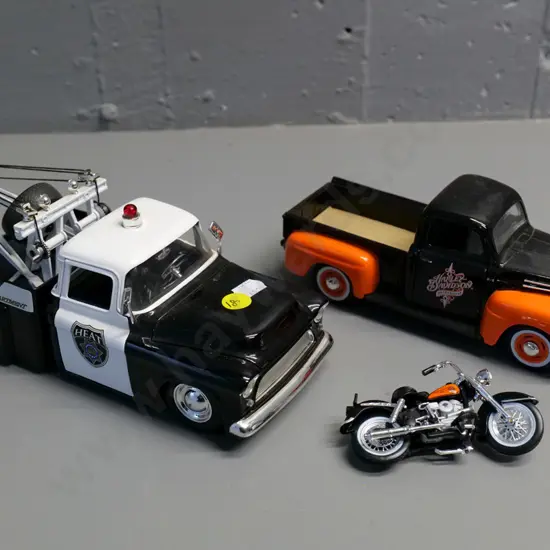 2 die-cast model trucks - 1:24 Jada Chevy step-side police tow truck & 1:25 Maisto Ford pickup with motorbike