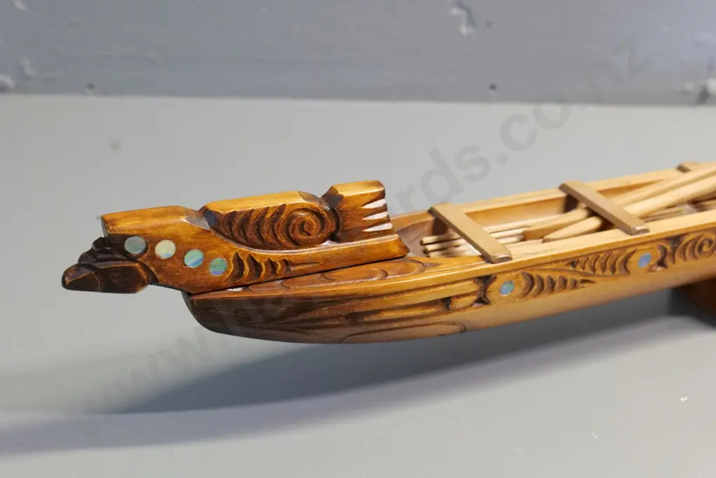 hand carved wooden waka model on wooden stand, with paddles, paua insets - has 'Te Aroha' sticker H280 L840 Image 1++