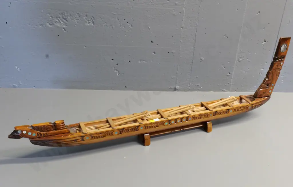 hand carved wooden waka model on wooden stand, with paddles, paua insets - has 'Te Aroha' sticker H280 L840 Image 1++