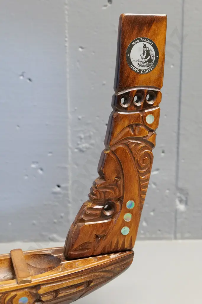 hand carved wooden waka model on wooden stand, with paddles, paua insets - has 'Te Aroha' sticker H280 L840 Image 1++