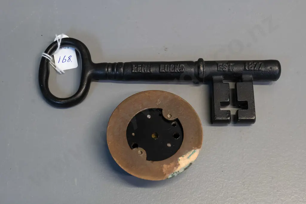 cast iron Penn Locks promotional key L-195 and a brass and enamel doorbell or buzzer button Image 1++