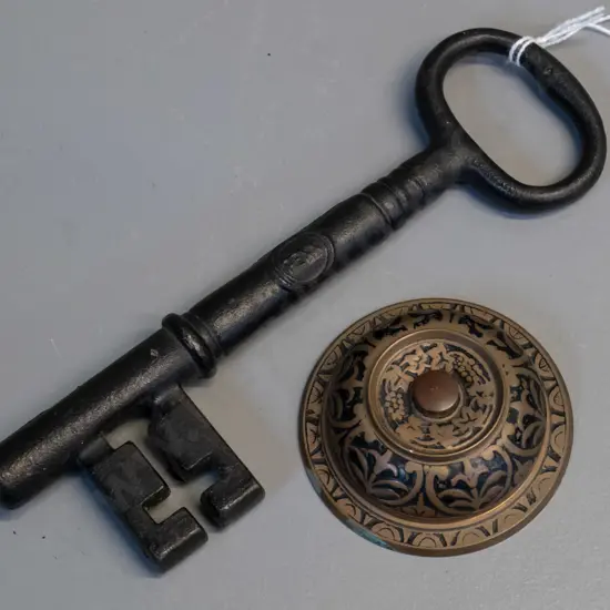 cast iron Penn Locks promotional key L-195 and a brass and enamel doorbell or buzzer button