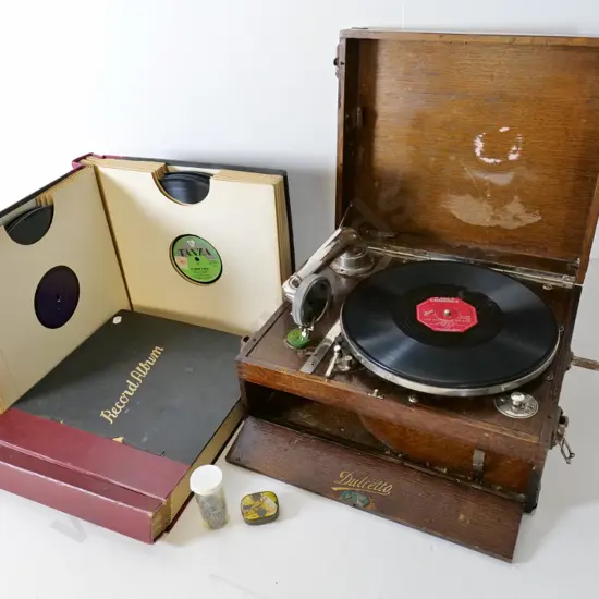 vintage Dulcetto portable wind-up gramophone and 2 albums of 78s plus needles - going condition, case needs attention