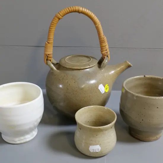 hand-potted teapot with cane handle and 3 small beakers, smallest has unknown maker's mark. Teapot H-230