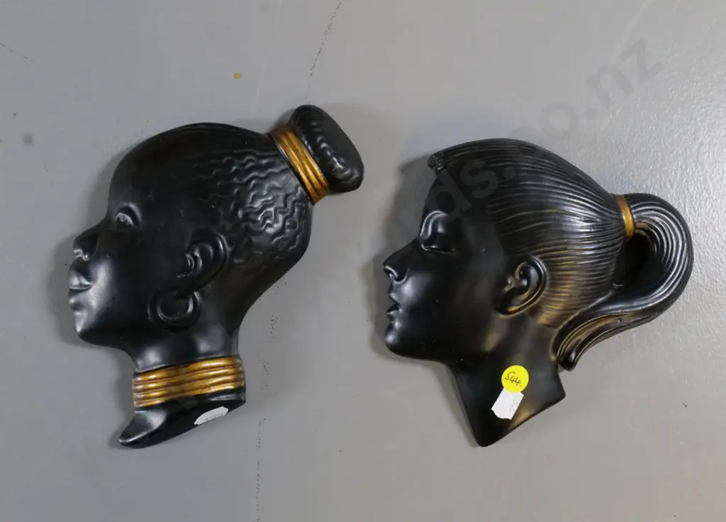 two black plaster wall silhouette heads - small chip on back of one, larger is H-180 Image 1++