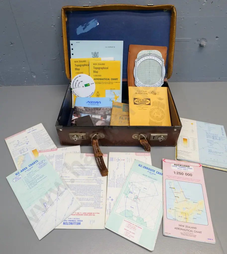 assorted pilot's aviation documents and navigation maps, calculators etc in battered small bullock hide Image 1++