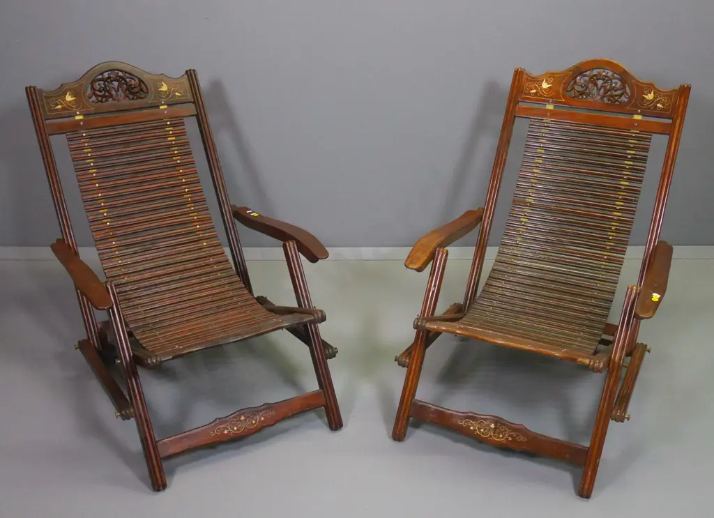 pair of Indian carved rosewood with brass inlay adjustable back slat-seat lounge/steamer chairs H800 W640 D1000 Image 1++