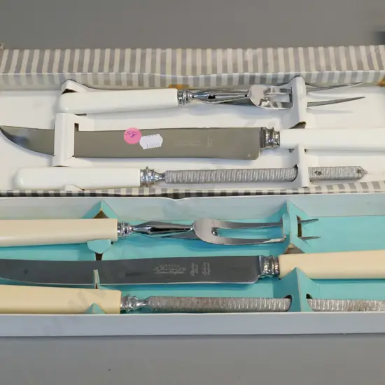 2 Sheffield carving sets - one bone handled, one faux ivory has some corrosion to sharpening steel