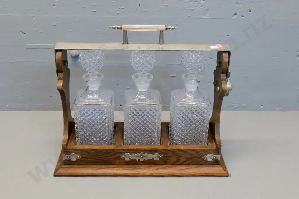 oak tantalus with 3 glass decanters, metal handle and corner binding H370 W410 D160 Image 1++