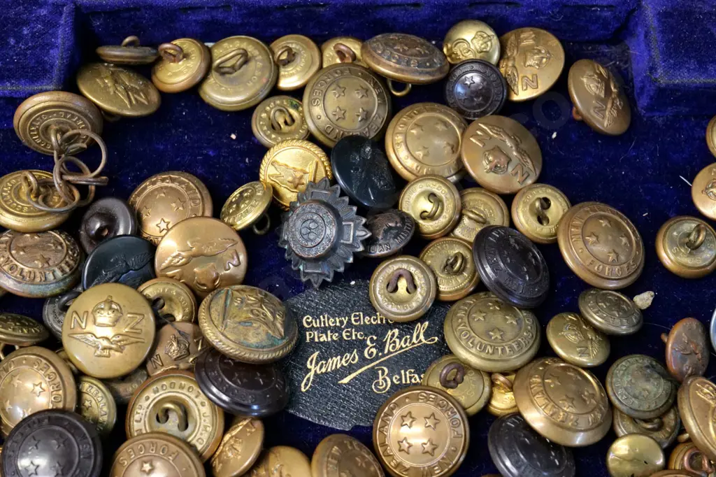 large assortment of brass & other military or uniform buttons - NZ, Australia, Canada etc on velvet lined wooden box lid Image 1++