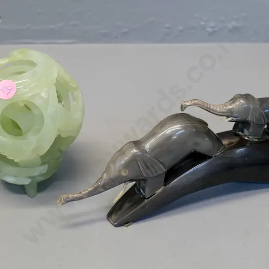 light green stone carved mystery ball D-100 on matching stone stand & a carved horn elephant pair L-200