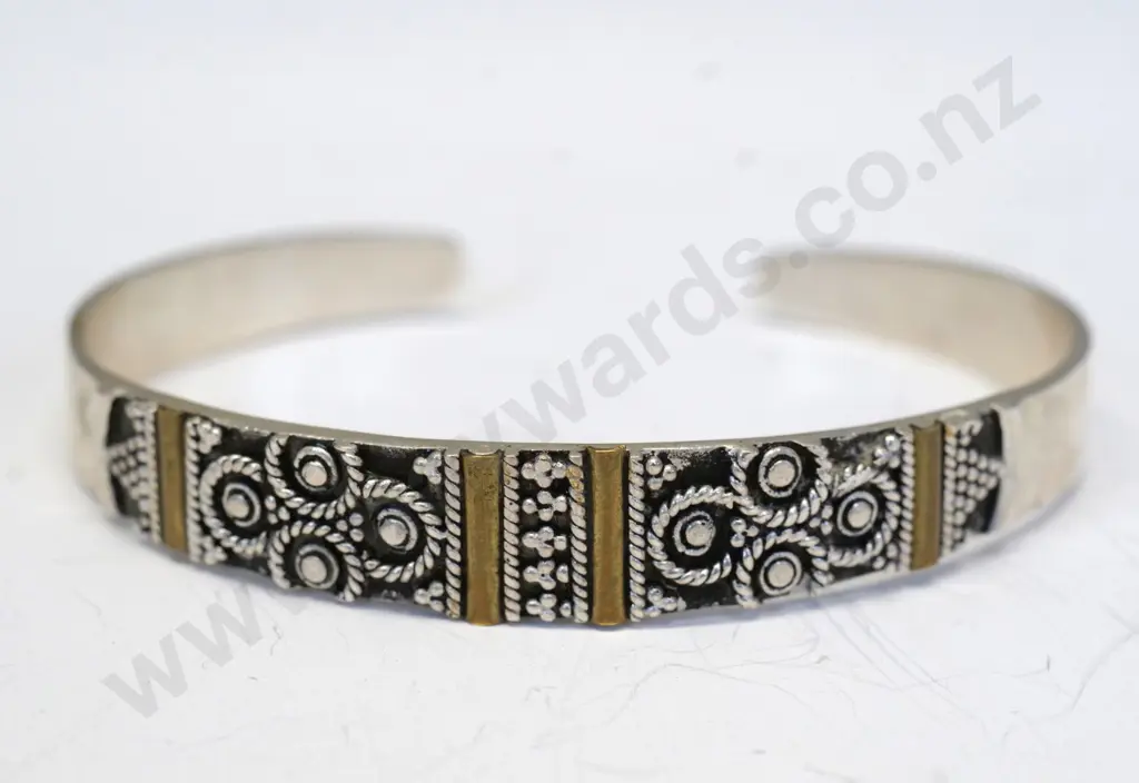 silver cuff bangle with design on top half Image 1++