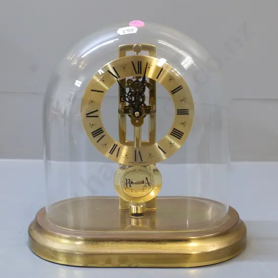 Reproduction battery powered skeleton clock with oval glass dome H-220 W-220