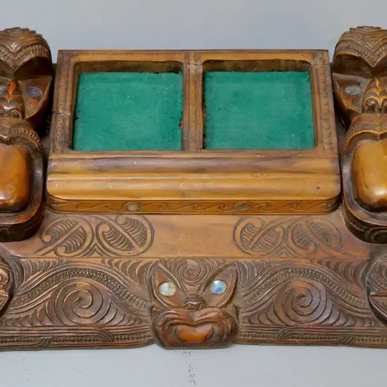 ornately carved Maori-motif desk organiser with paua insets - one missing - minor cracking W-360 D-220