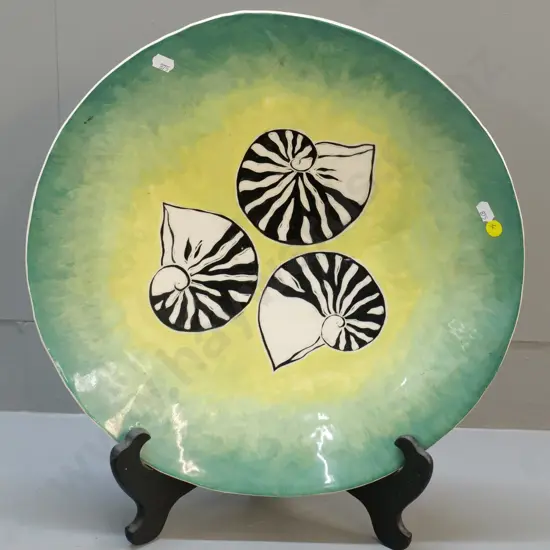 large pottery wall charger with hand-painted nautilus design - firing cracks on back, one visible on front. Diameter 410