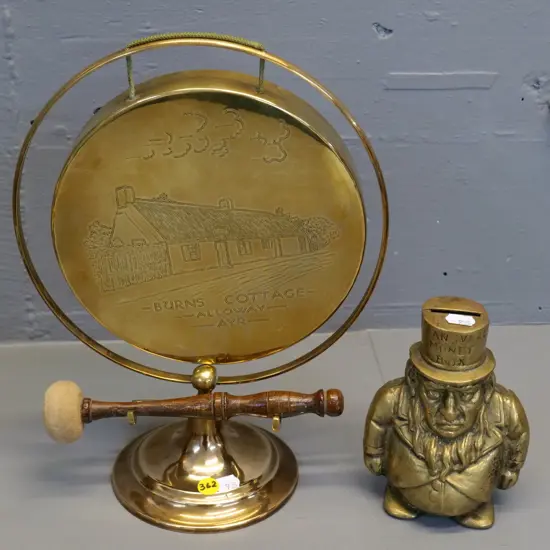 brass 2-part Kruger figural "Transvaal money box" and a souvenir Burns Cottage gong and stand with wooden beater H320