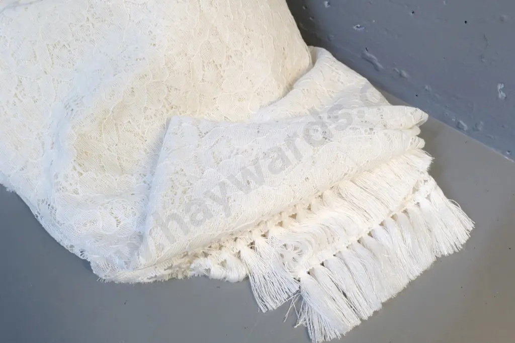 pair of single bed throws with traditional lace and fringed edges - one is a darker cream colour Image 1++