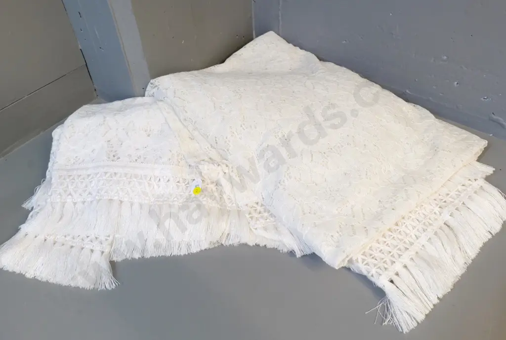 pair of single bed throws with traditional lace and fringed edges - one is a darker cream colour Image 1++
