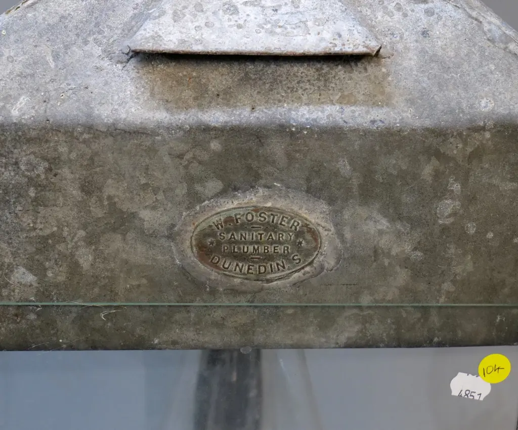 large triangular tin kerosene lantern, 2 plaques with "W Foster Sanitary Plumber Dunedin S" - chimney cracked H530 W300 Image 1++