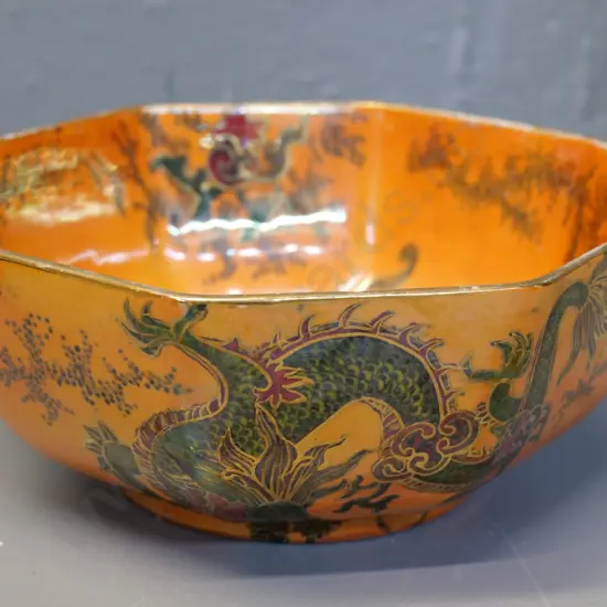 Bursley octagonal lustre bowl with dragon motif - some rubbing to gilt around rim. Diameter 180