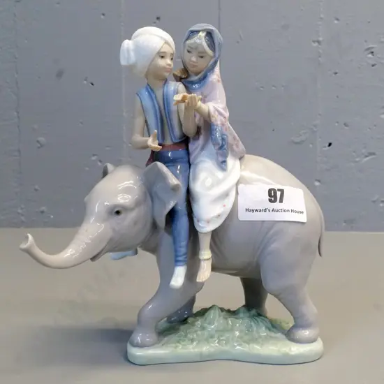 Ladro figurine couple riding elephant, boy has repair to left arm H-240