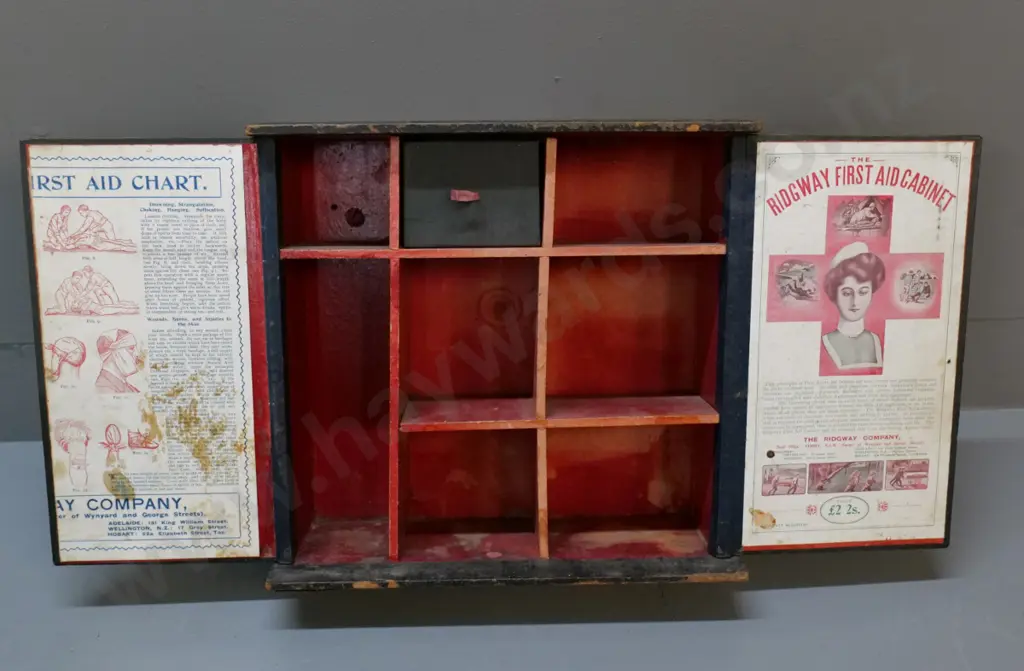 vintage wooden first aid cabinet with small metal catch - made by Ridgway, wear & tear, 1 printed paper panel missing Image 1++