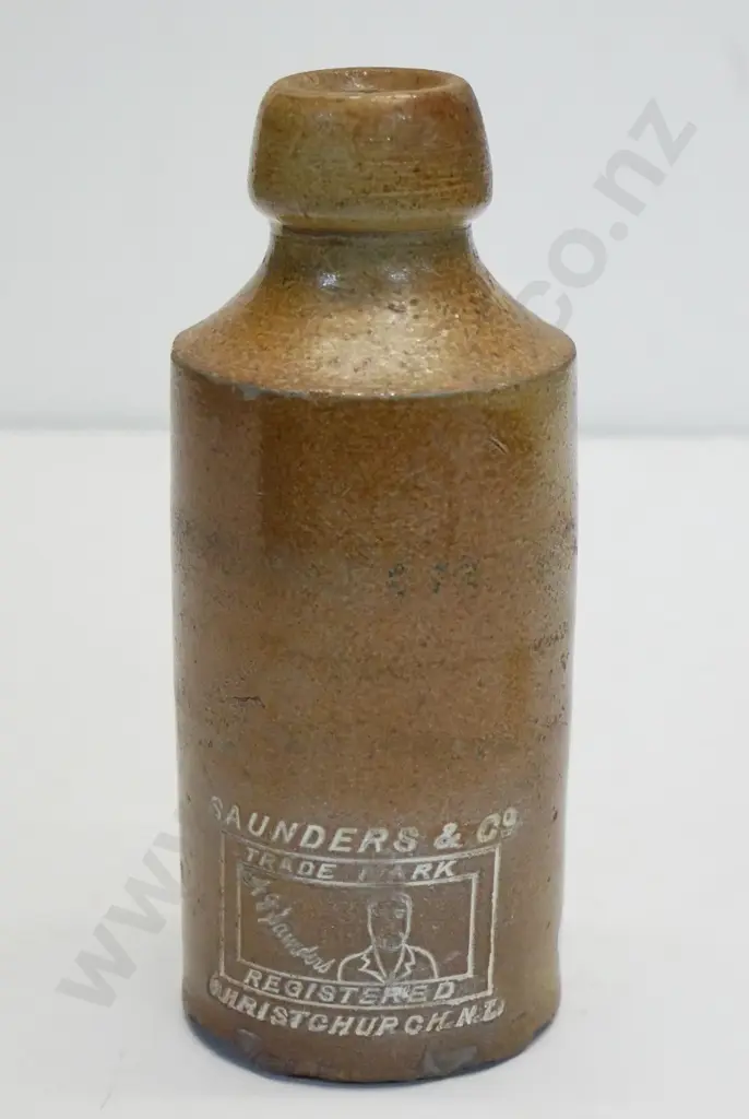 Dumpy ginger beer bottle, Saunders and Co, Christchurch, maker Bourne Denby 03, condition poor, H -170 Image 1++