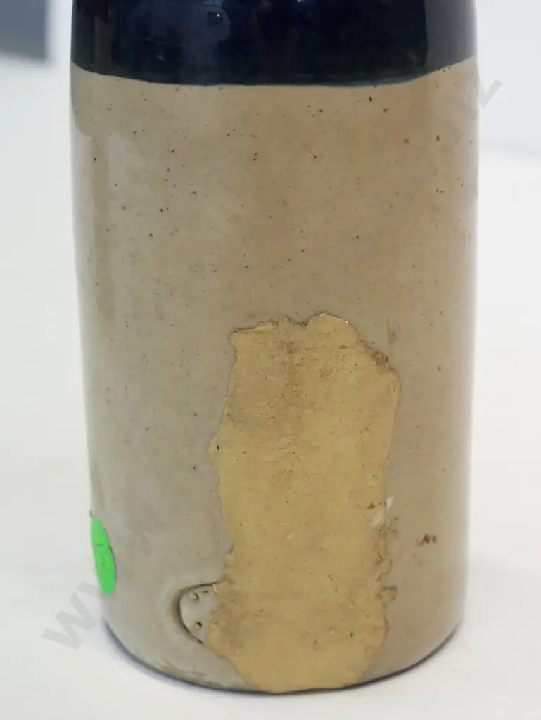 Ginger beer, crown cap, T West and Co, Dunedin, condition poor, has been filled at back, H - 210 Image 1++