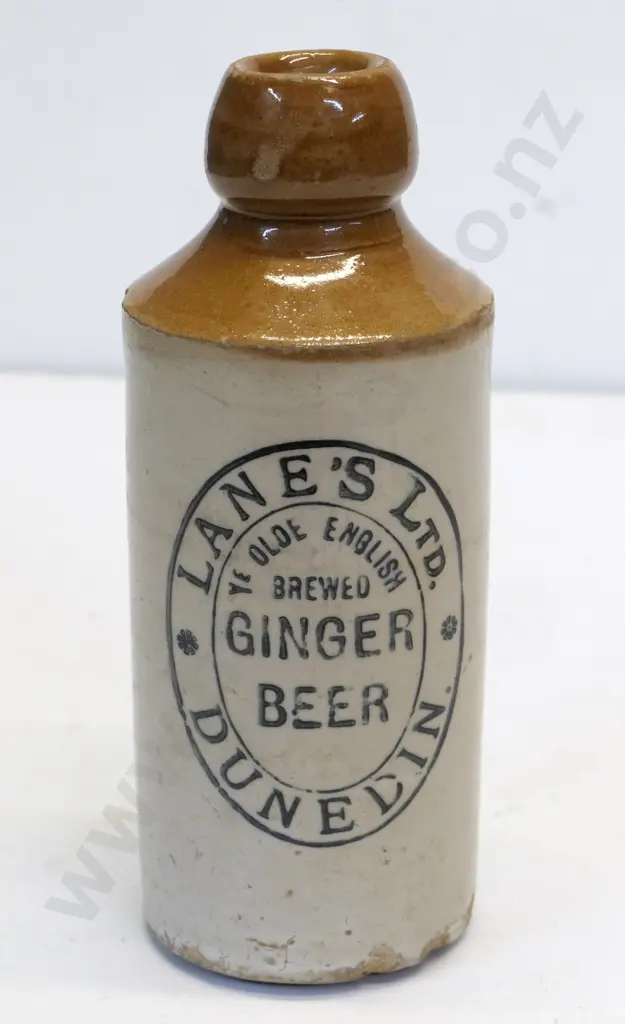 Dumpy ginger beer bottle, Lanes Ltd Dunedin, condition poor, chips to base, H - 170 Image 1++