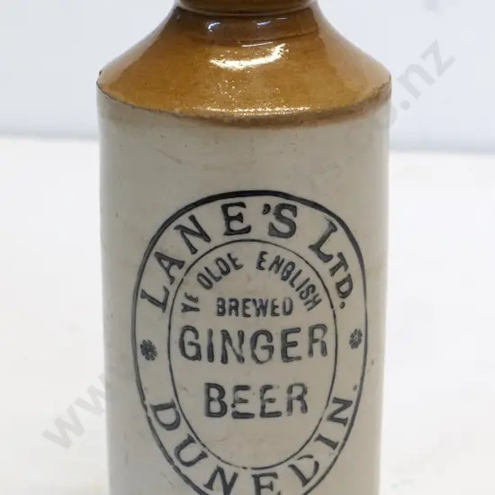 Dumpy ginger beer bottle, Lanes Ltd Dunedin, condition poor, chips to base, H - 170