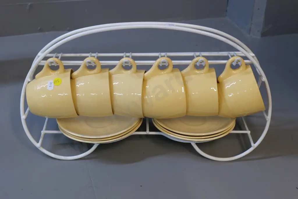 6 early Crown Lynn cups & saucers - saucers lighter colour than cups - and coated wire rack Image 1++