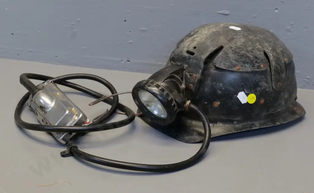 black fibre miner's helmet with lamp cord and fitting - light housing marked Oldham & Son Manchester . Wear and tear Image 1++
