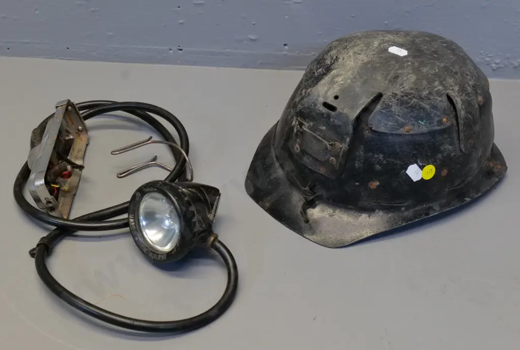 black fibre miner's helmet with lamp cord and fitting - light housing marked Oldham & Son Manchester . Wear and tear Image 1++