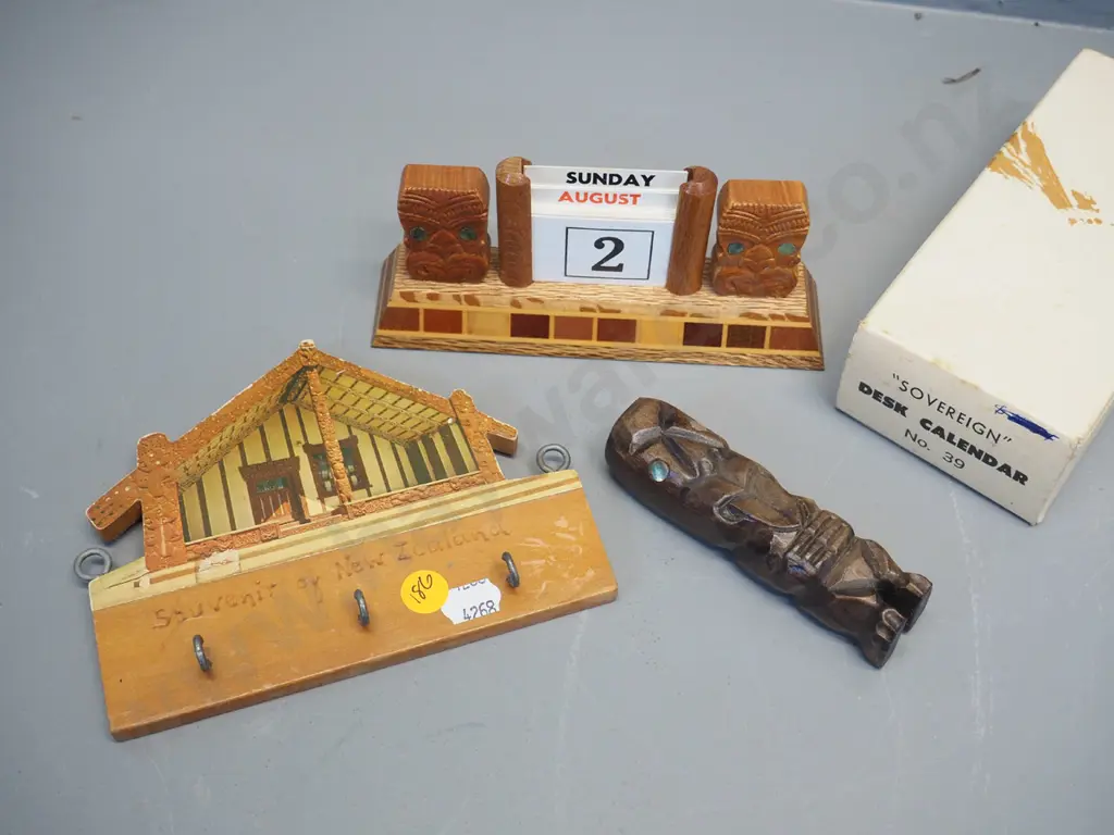 3 New Zealand souvenir items - Sovereign ware desk calendar (cards complete) small carved wooden tiki, and a key holder Image 1++