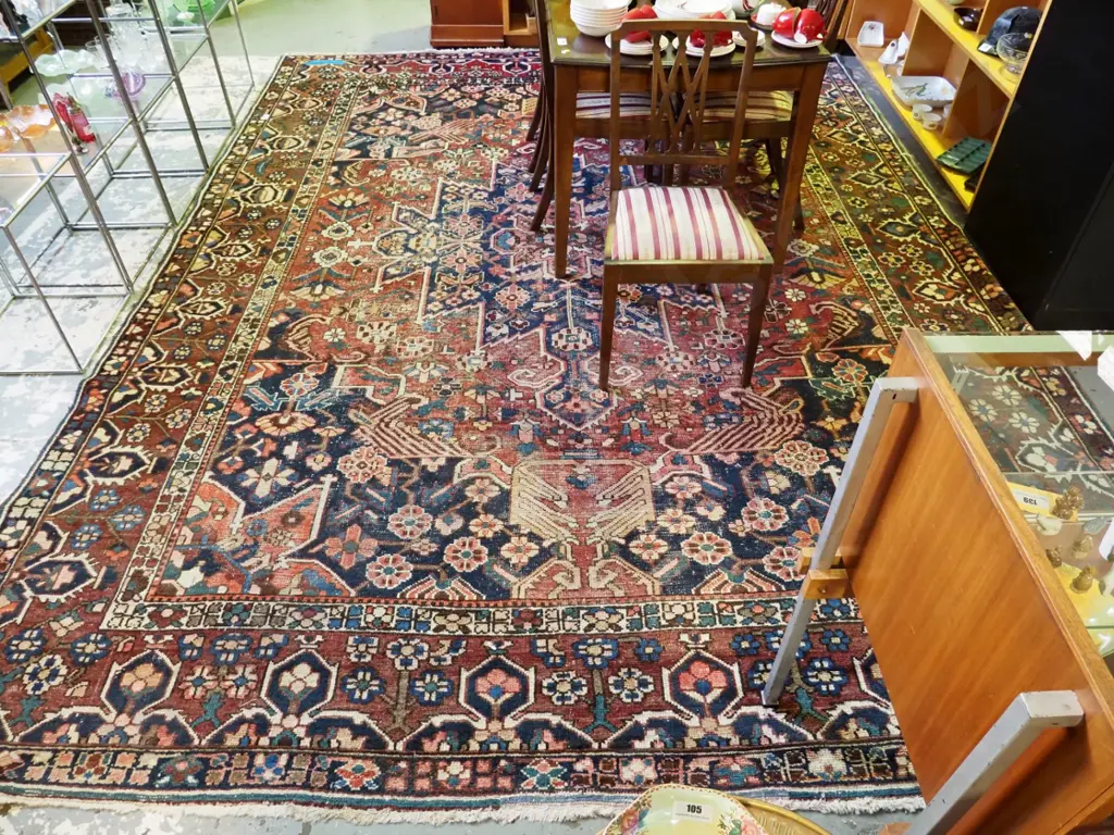 large Persian style hand-knotted wool floor rug - considerable wear to centre area L3780 W3000 Image 1++