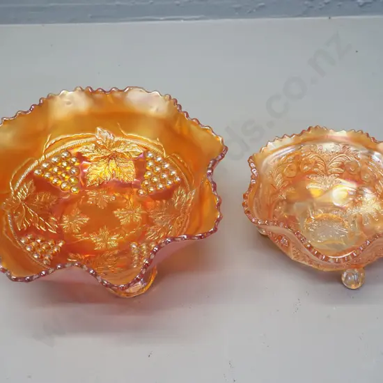 2 marigold carnival glass footed bowls - larger one grape pattern D-200, other is cat motif