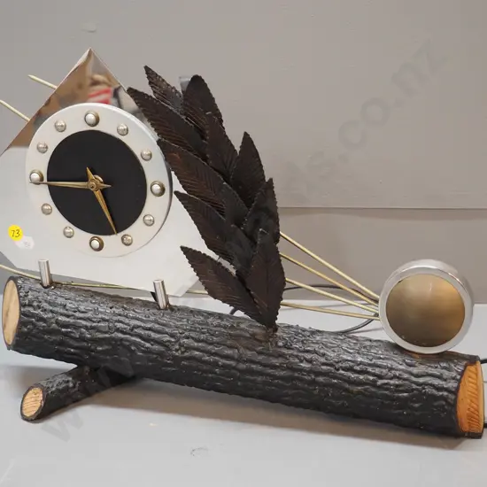 electric table / mantel clock with heavy faux log metal base, chrome face, metal leaves and sunburst H310 W440