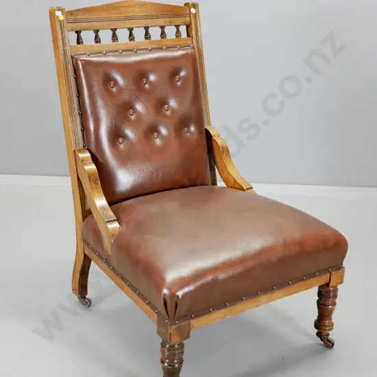 Edwardian timber framed spindle back lounge chair with button back faux leather upholstery, porcelain casters H920 W600