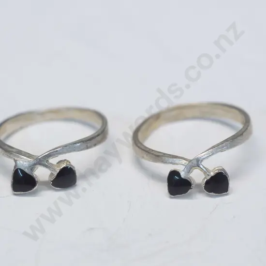 2 silver rings with 2 small red hearts stamped 925