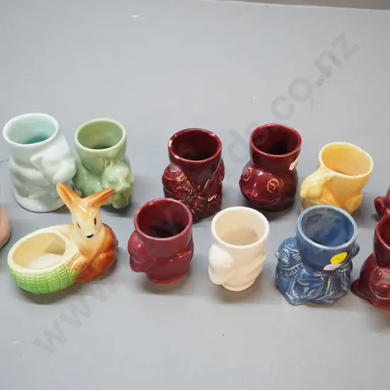 collection of 12 vintage egg cups including Crown Lynn - bulldog, rabbits, clown, squirrel, etc.