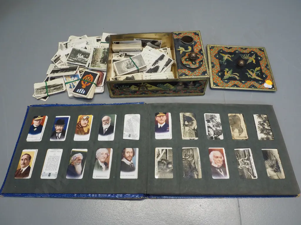Three Castles cigarette card album and numerous loose cards in a vintage printed tin writing box Image 1++