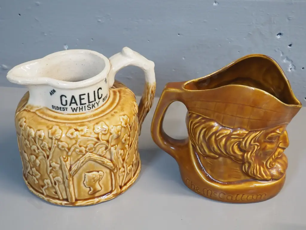 2 whisky jugs: Old Smuggler w/Port Dundas stamp on base, has chip off relief decoration H170 W200, and McCallum Image 1++