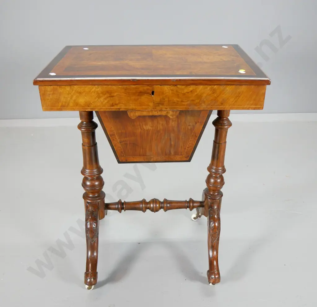 Victorian sewing table with burr veneer top (w/split), carved base, porcelain casters, restored satin interior H700 Image 1++
