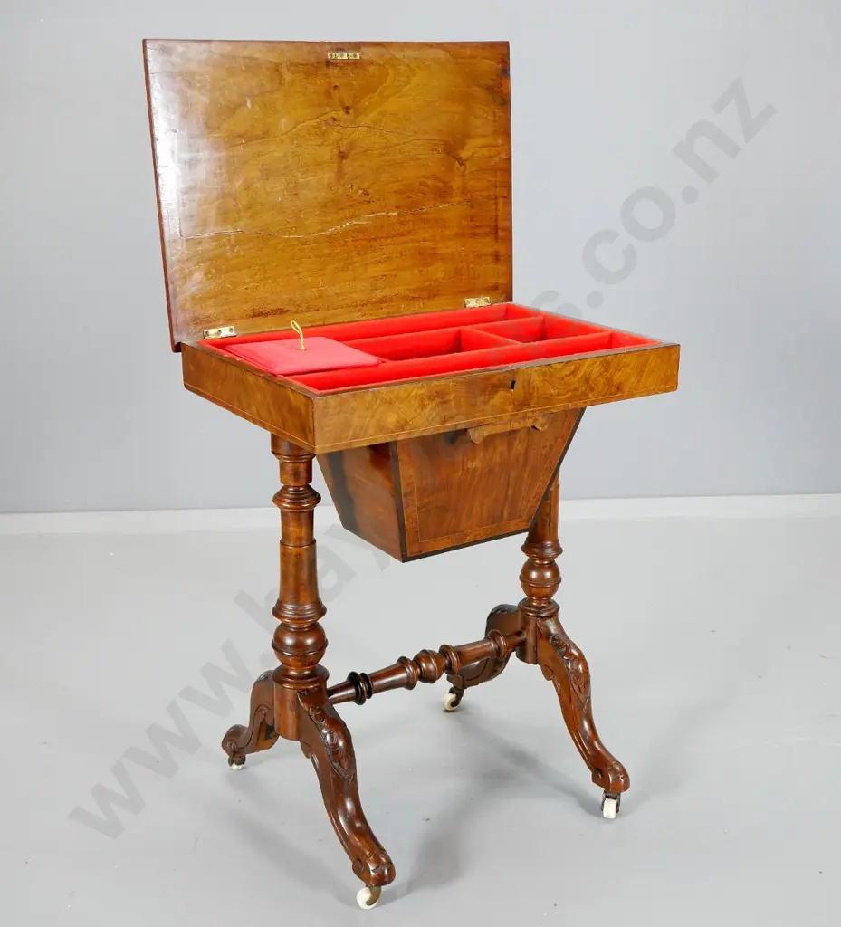 Victorian sewing table with burr veneer top (w/split), carved base, porcelain casters, restored satin interior H700 Image 1++