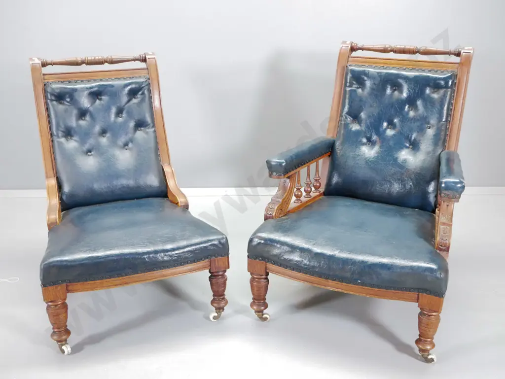 pair Edwardian carved oak w/studded dark blue lounge chairs with spindles - some cracking to vinyl H950 W700 D830 Image 1++
