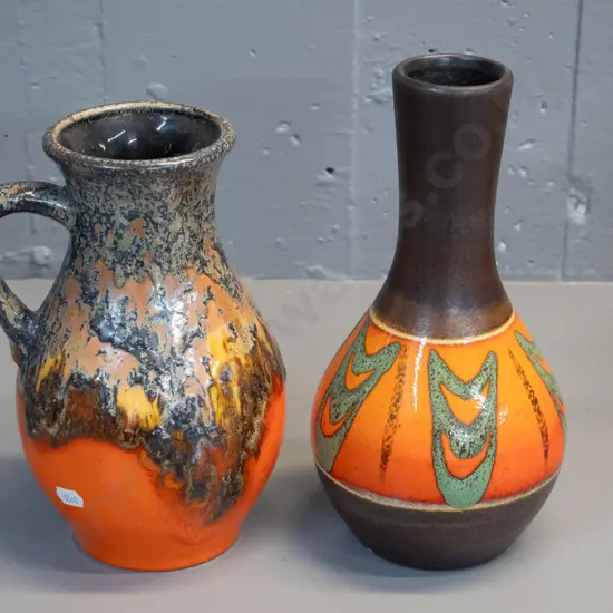 2 German pottery vases - orange and brown glazes, handled one with drip glaze, taller has small fleck H260