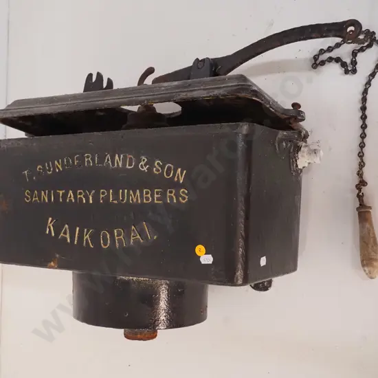 cast iron wall mount toilet cistern, marked T. Sunderland & Son Kaikorai, with timber pull - some corrosion H480 W570
