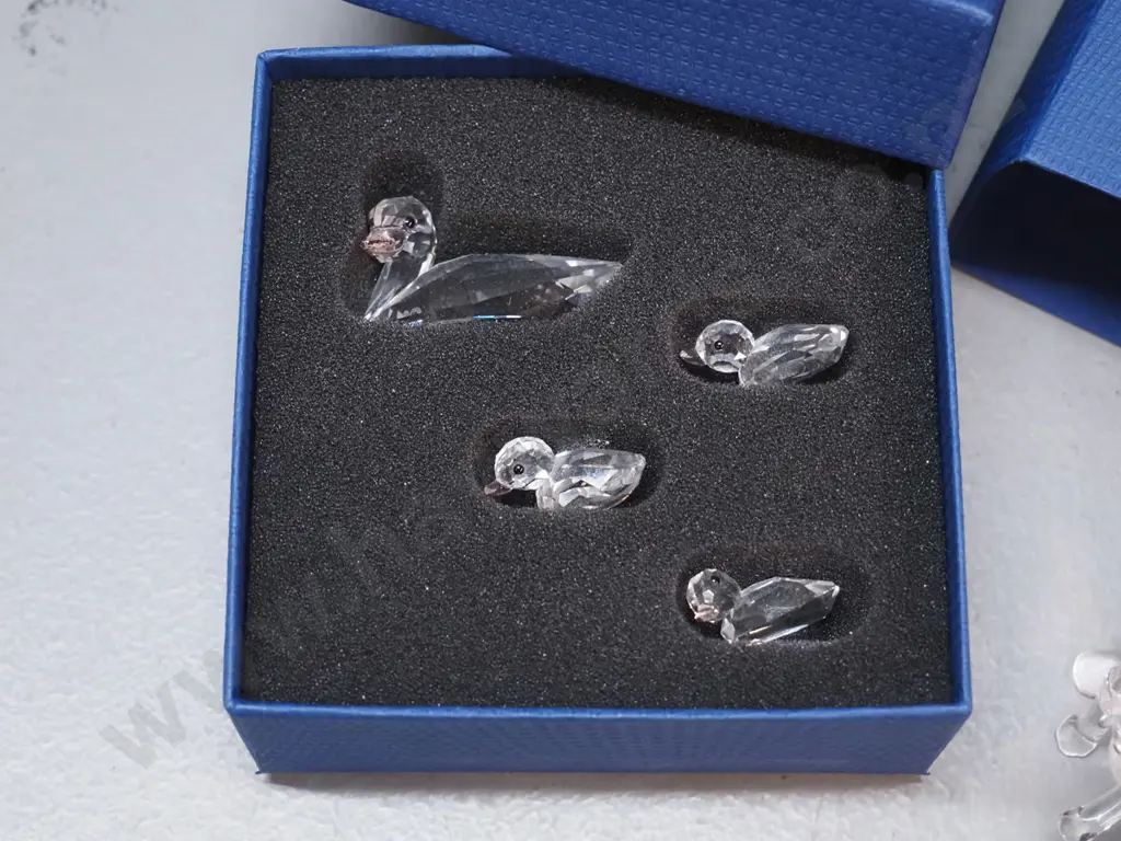 3 Swarovski crystal items - boxed duck w/3 ducklings, cat and rabbit - and a small marbled blue glass bird Image 1++