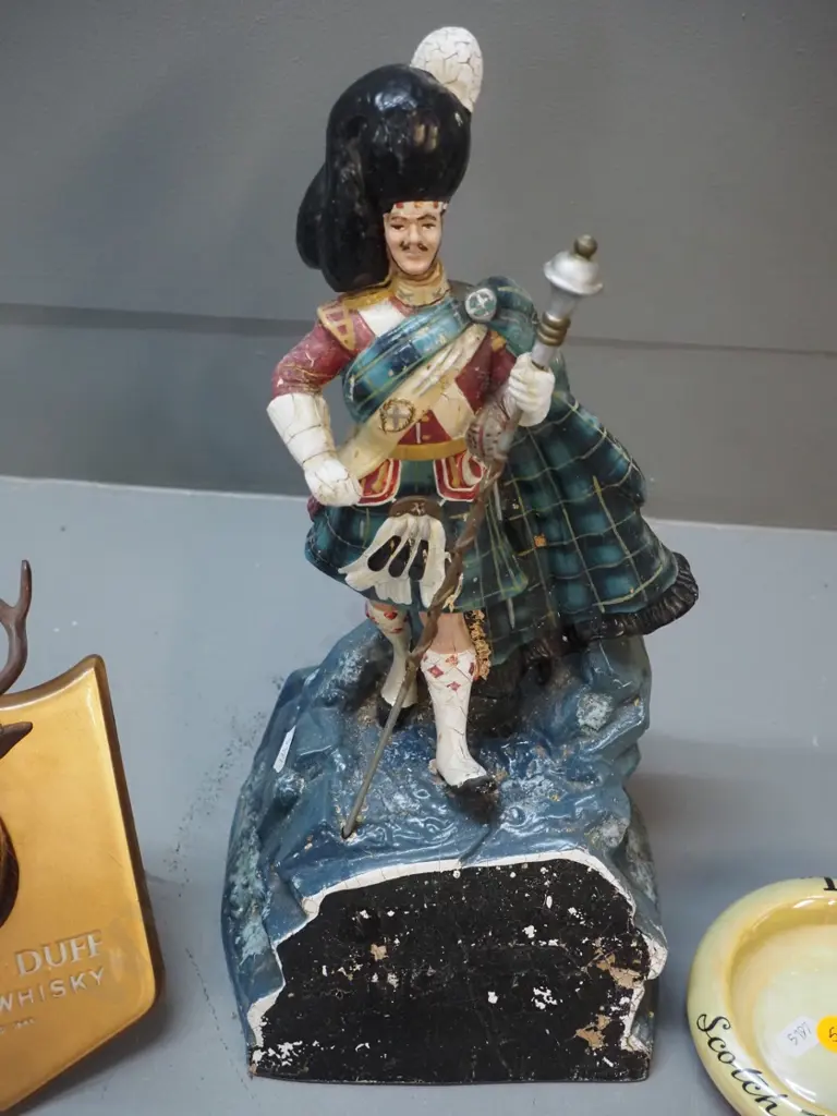 whisky items - Dewar's piper figure with finish wear H-350, Maclay-Duff stag's head plaque, DCL ashtray Image 1++